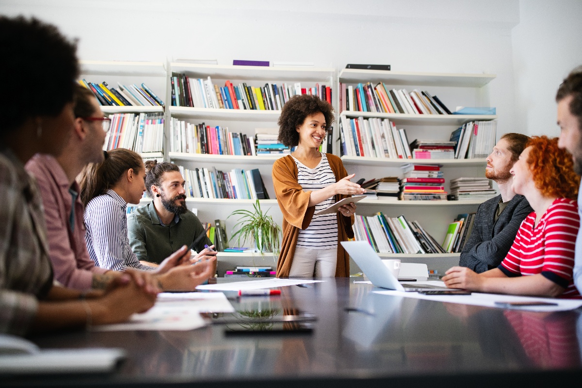 woman giving presentation to her co=workers