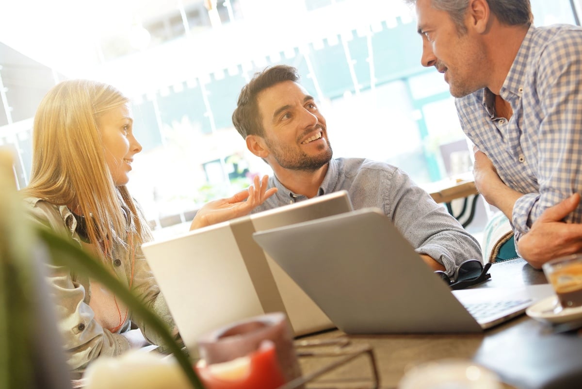 business people chatting over laptops