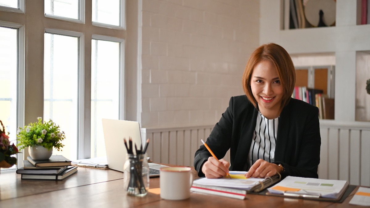 Lady smiling and working at desk 