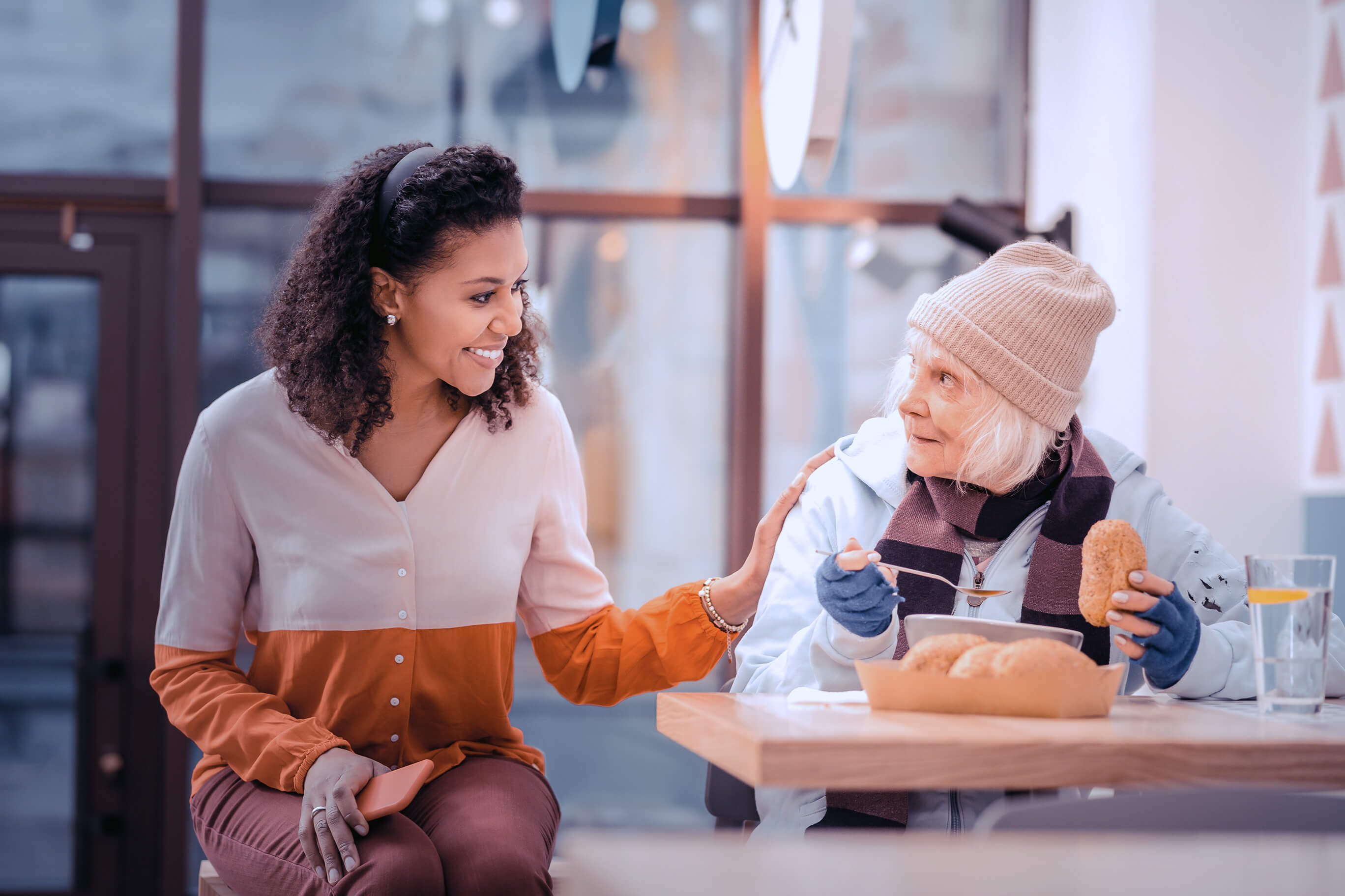 young woman with older woman experiencing homelessness