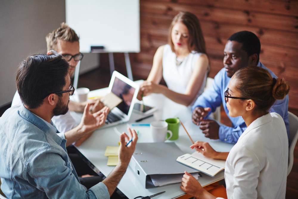 people brainstorm around table