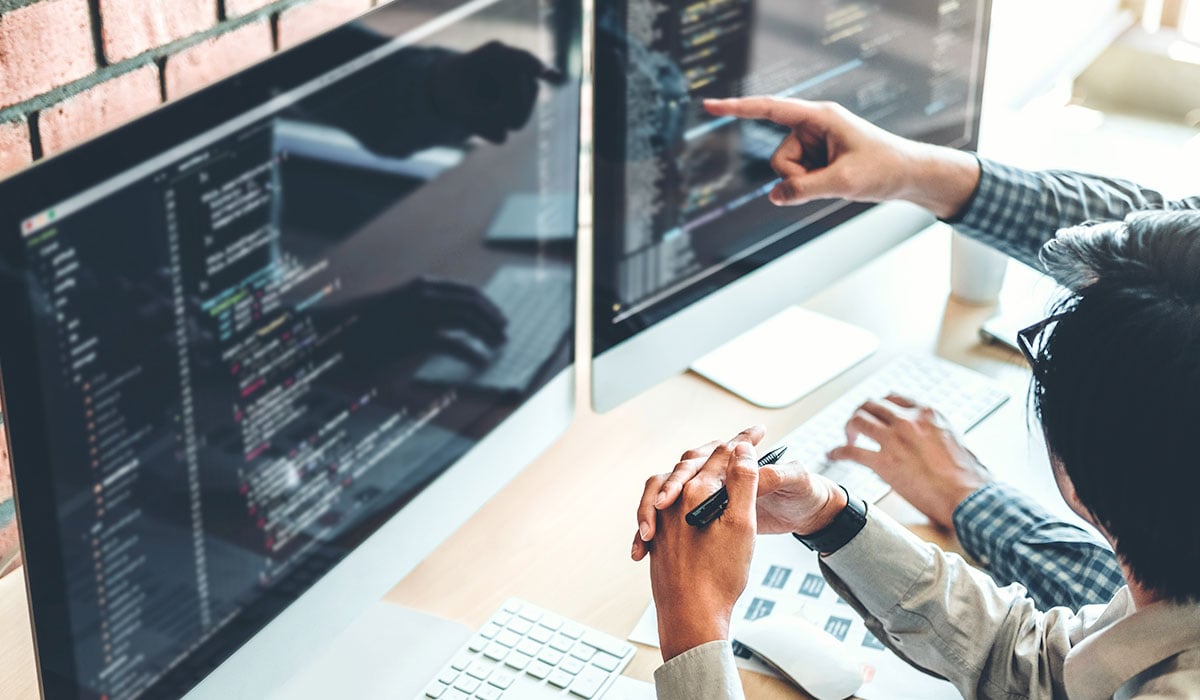 developer looking at computer screen filled with code